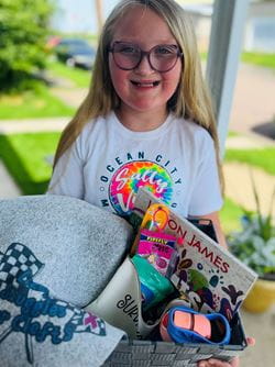Lizzy Vogel holding a basket and smiling